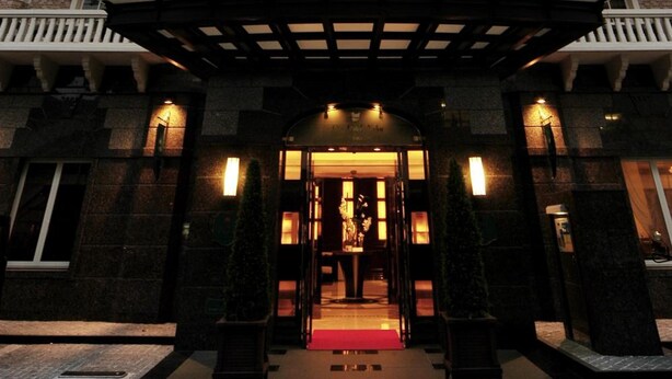 A multi-story hotel with a symmetrical facade, balconies, and a central entrance with a red carpet. - GRG Hotel Naha Higashimachi (Naha)