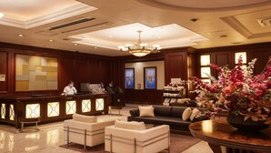 A hotel lobby with a reception desk, seating area, and decorative elements. - GRG Hotel Naha Higashimachi (Naha)