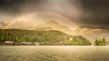A lakeside resort with multiple cabins and a mountain backdrop.