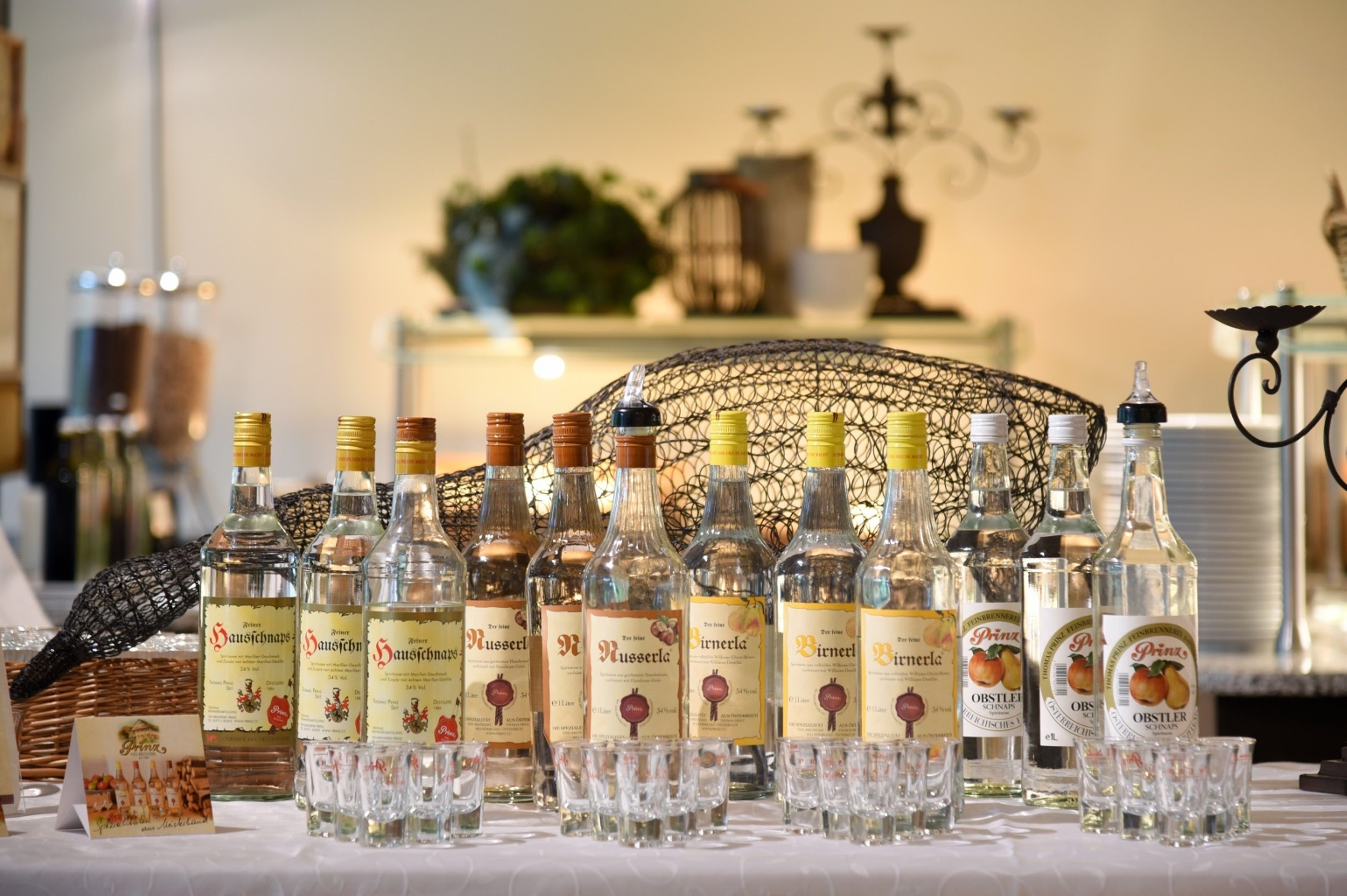 A display of various bottles and glasses on a table, likely for a tasting event.
