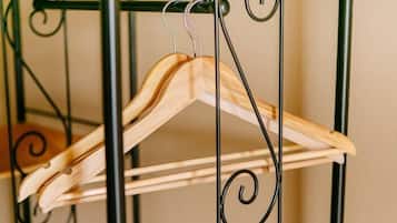 A metal hanger rack with wooden hangers.