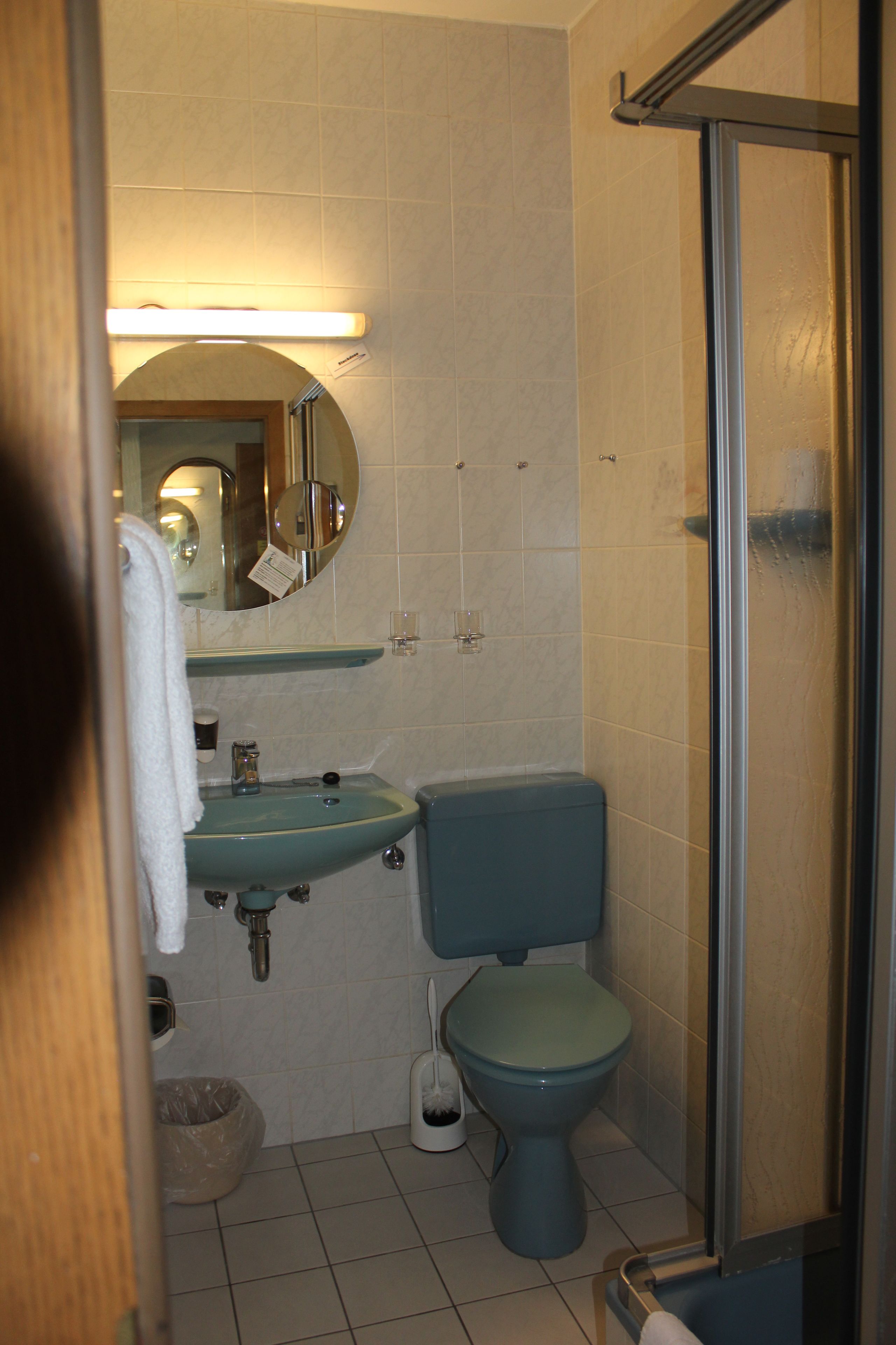 A bathroom with a sink, toilet, and shower.