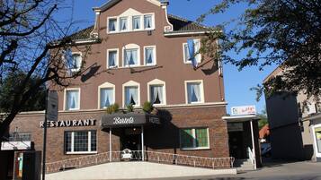 A two-story building with a sign for 'Bartels' restaurant and 'Hotel'.