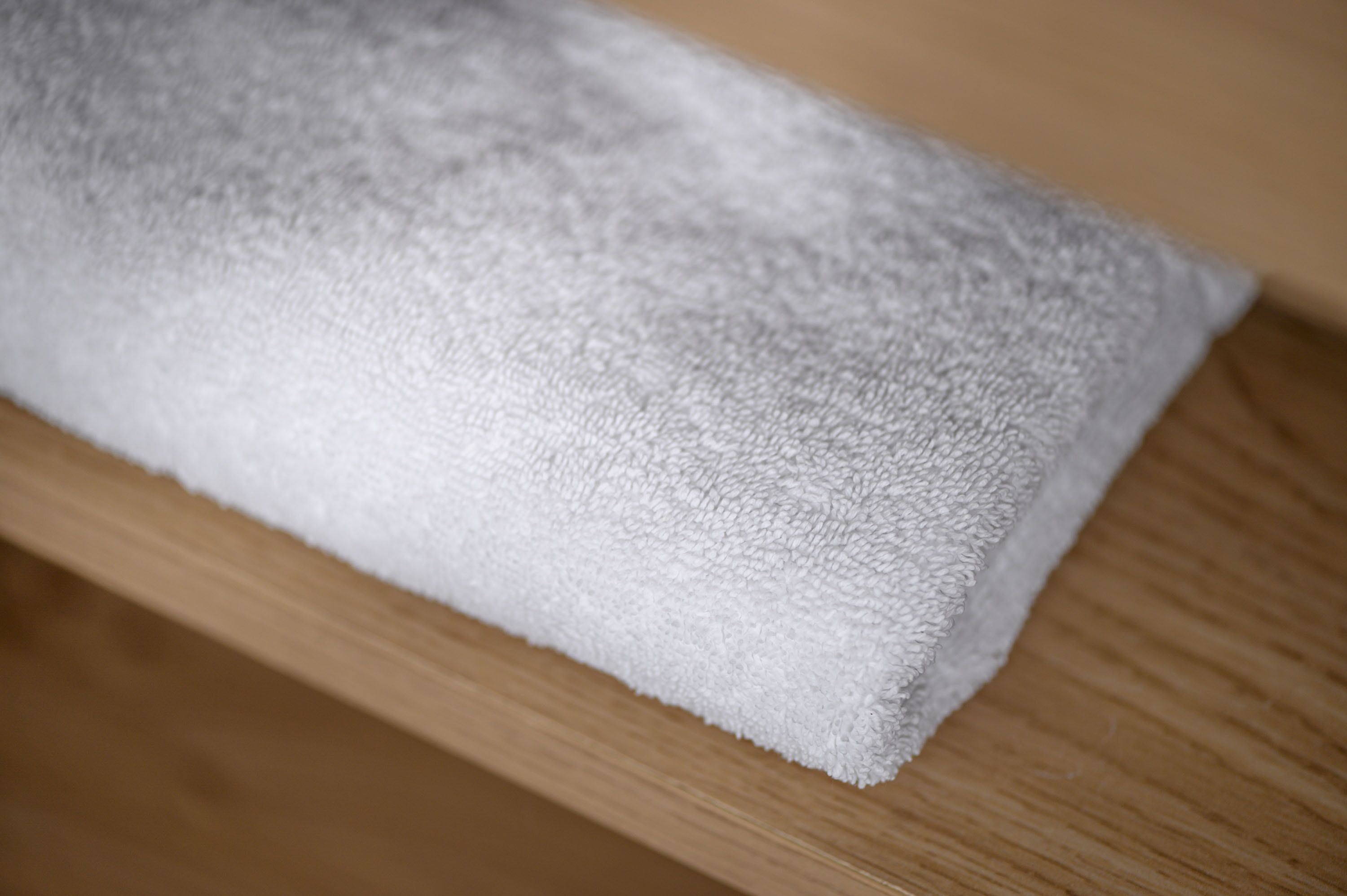 A white towel on a wooden surface.