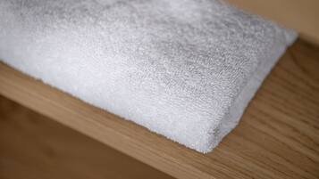A white towel on a wooden surface.