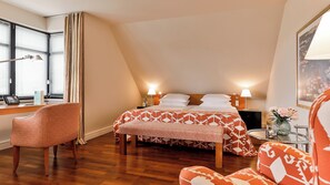A hotel room with a bed, two chairs, a desk, and a window with blinds. - Zeller Hotel & Restaurant (Kahl)