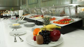 Ein reichhaltiges Buffet mit verschiedenen Früchten und Gemüsesorten, darunter Äpfel, Bananen und Orangen.