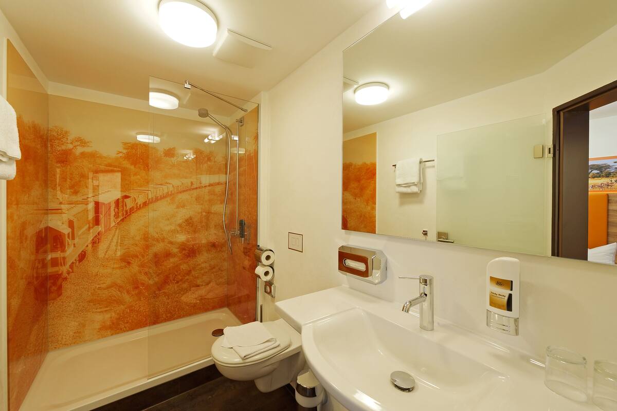 comfort quad room for 2 adults and 2 children | bathroom | hair dryer, towels