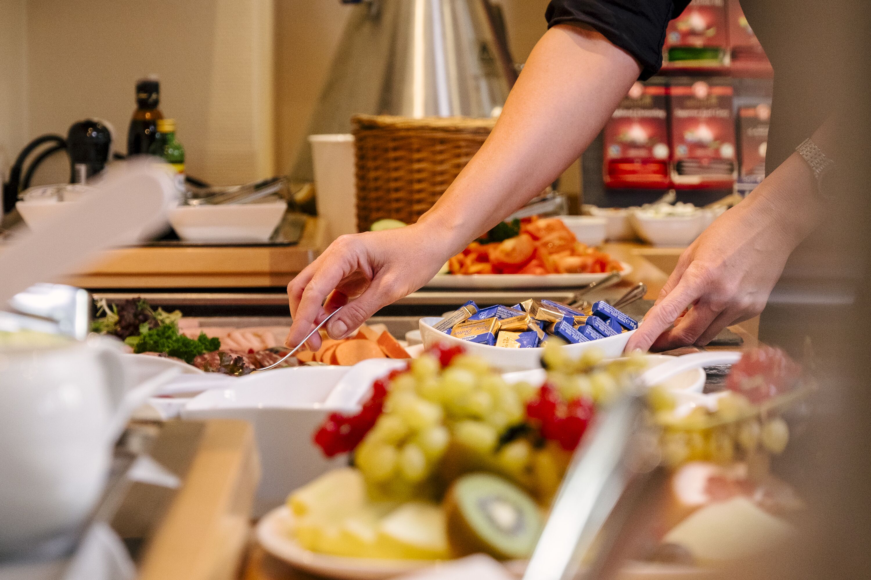 A buffet with various food items including fruits, vegetables, and prepared dishes.