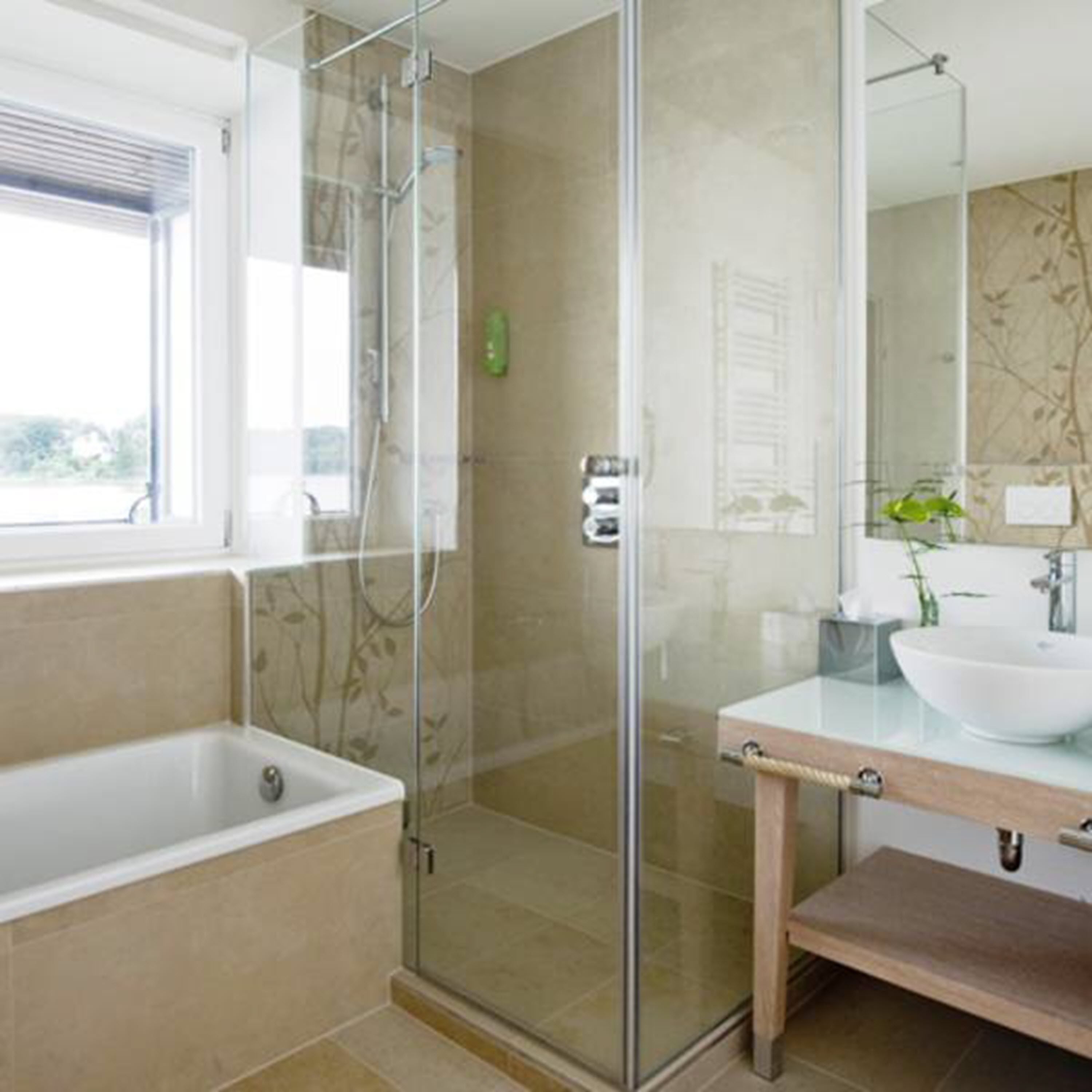 A modern bathroom with a glass-enclosed shower, a bathtub, and a vanity with a sink.