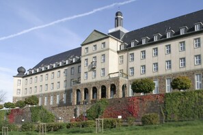 A large, historic building with multiple windows and a prominent tower. - Kardinal Schulte Haus (Bergisch Gladbach)
