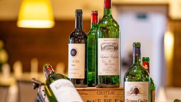 A wooden display with wine bottles and a metal sculpture.