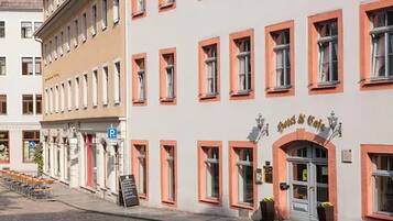 A building with a row of windows and a sign that reads "Cafe & Cafe".