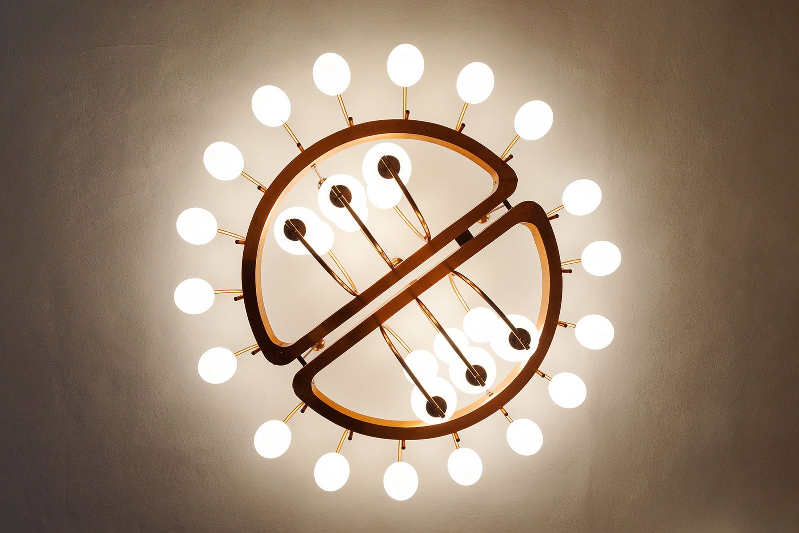 A ceiling light fixture with a circular design and multiple bulbs.