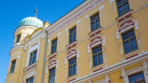 A yellow building with a sign for the Grand Hotel. - Grandhotel Garni (Jihlava)
