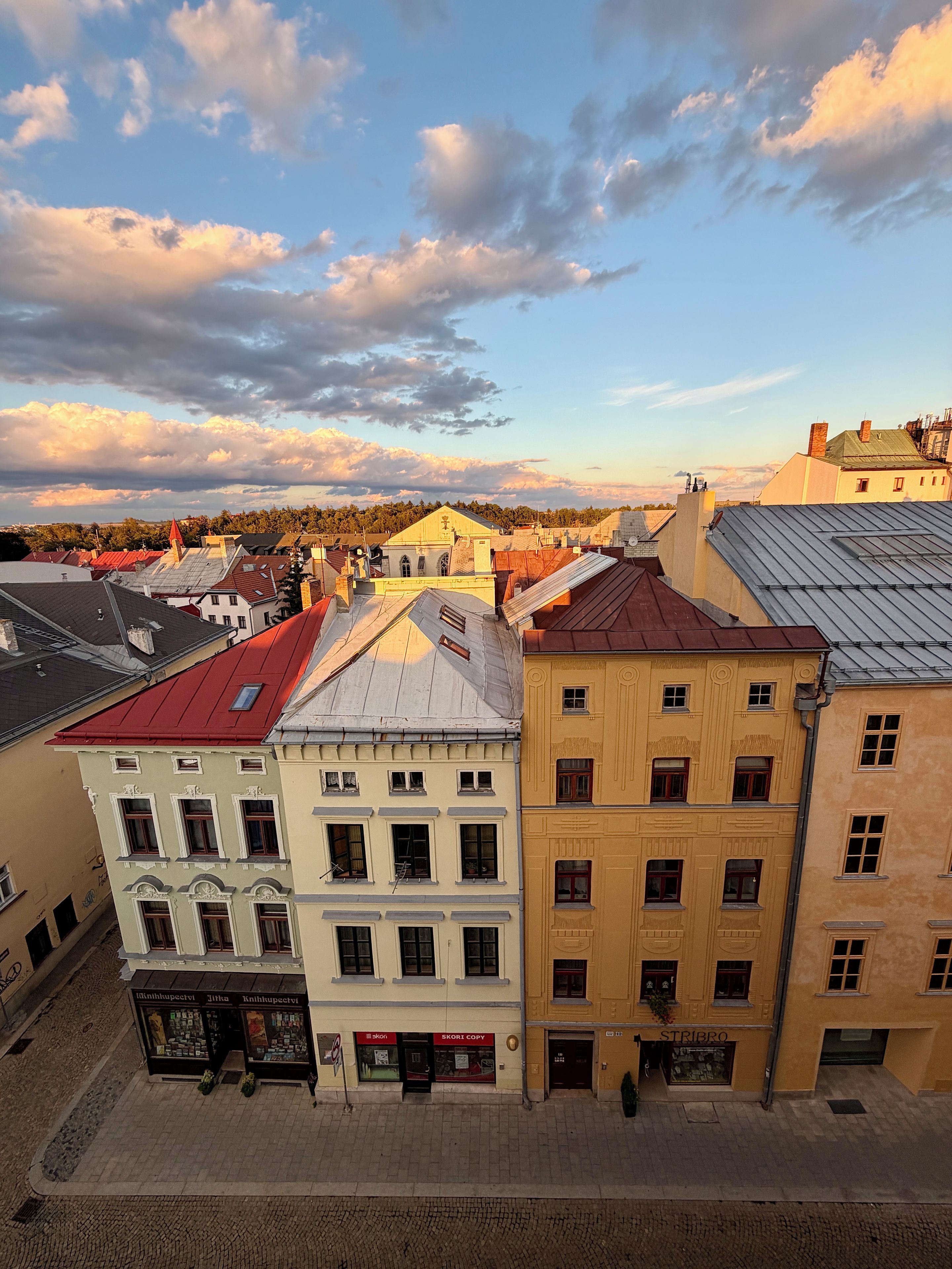A street view with buildings, a shop, and a clear sky.