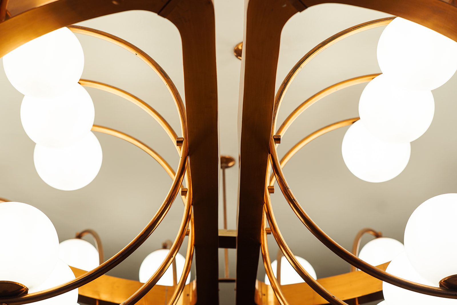 A symmetrical, mirrored ceiling design with circular light fixtures.