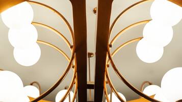 A symmetrical, mirrored ceiling design with circular light fixtures.