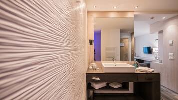 A modern bathroom with a large mirror, a sink, and a vanity.