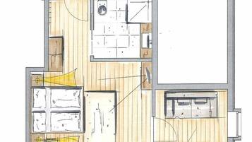 Un plan d’étage d’une chambre d’hôtel comprenant une salle de bain, un coin cuisine et un espace salon.