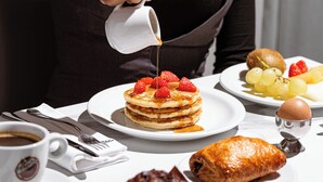 A breakfast setting with pancakes, strawberries, and a croissant. - Phi Hotel Pianfei (Pianfei)
