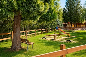 A playground with a seesaw, a slide, and a swing set. - Phi Hotel Pianfei (Pianfei)