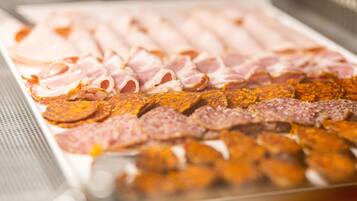 A variety of sliced meats on a tray.
