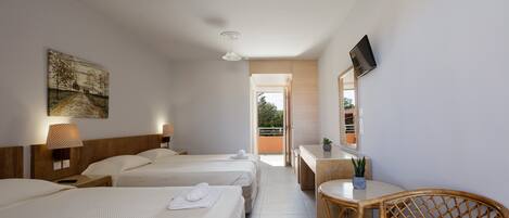 A hotel room with three beds, a desk with a chair, a TV, and a painting on the wall.