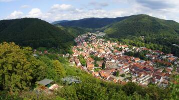 A town nestled in a valley surrounded by hills, featuring a mix of residential buildings and greenery.