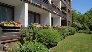 A multi-story building with balconies adorned with flower boxes.