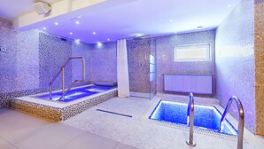 A modern indoor swimming pool with mosaic tile walls and a glass-enclosed area. - Hotel Marie Luisa (Prague)