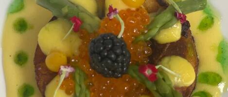 A dish with various toppings and garnishes.