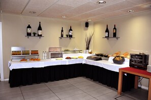 A buffet setup with various food items and beverages.