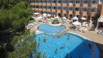 Relax by the pool surrounded by sun loungers and umbrellas, with stunning views from the upper levels.
