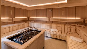 Un spa moderne avec des panneaux de bois, un grand jacuzzi central et des espaces de détente.