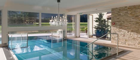 Indoor pool, pool umbrellas, pool loungers