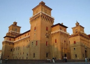 A large, historic building with multiple towers and a central courtyard. - Da Santo (Ferrara)