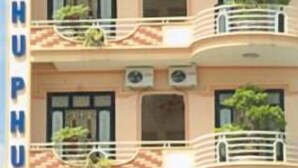 A multi-story hotel with balconies, air conditioning units, and potted plants. - Nhu Phu Hotel (Hue)