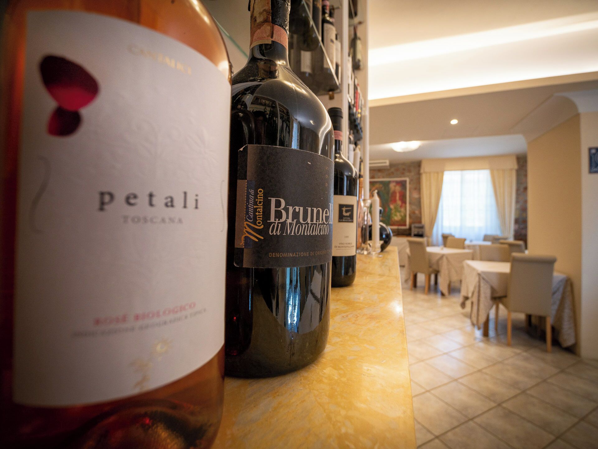 A bar area with bottles of wine, including a bottle labeled "Brunello di Montalcino."