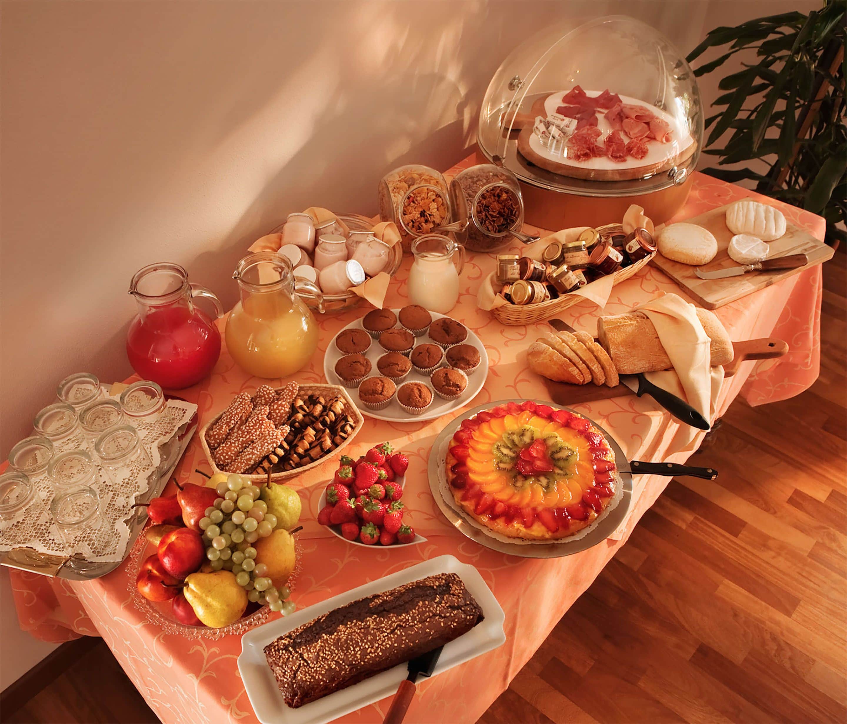 A breakfast buffet with various food items and drinks.