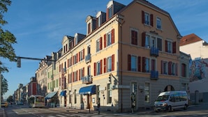 A multi-story hotel with a classic European architectural style, featuring balconies and a central entrance. - Les Capucins (Belfort)