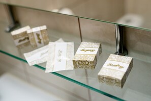 A glass display case with several boxes, each with a gold pattern and the word "Baby" on them. - Hotel Regal (Brasov)
