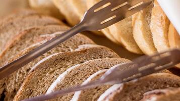 A basket of sliced bread with a fork and knife.