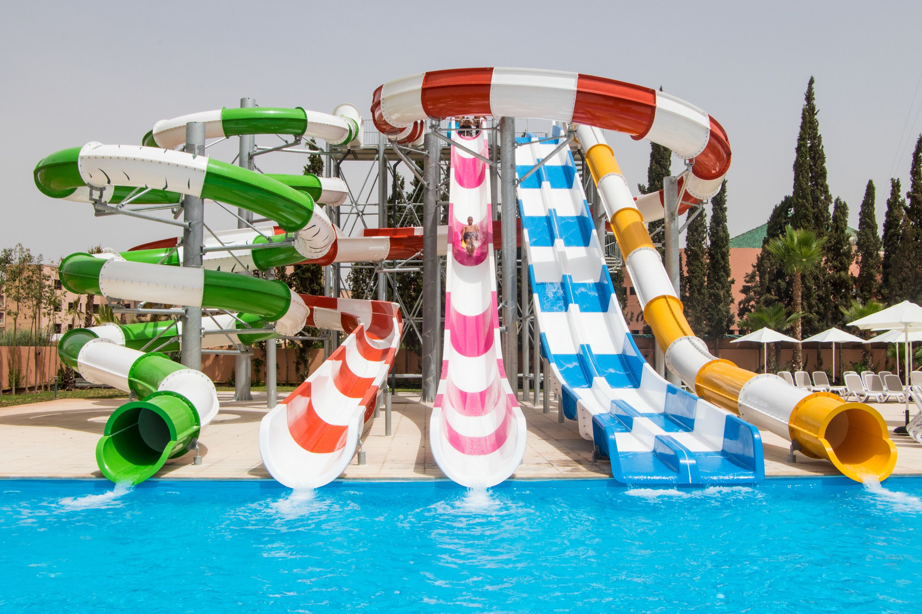A water park with multiple slides and a pool.