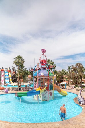 A water park with a central pool, slides, and palm trees. - Rose Aqua Park Hotel (Marrakech)
