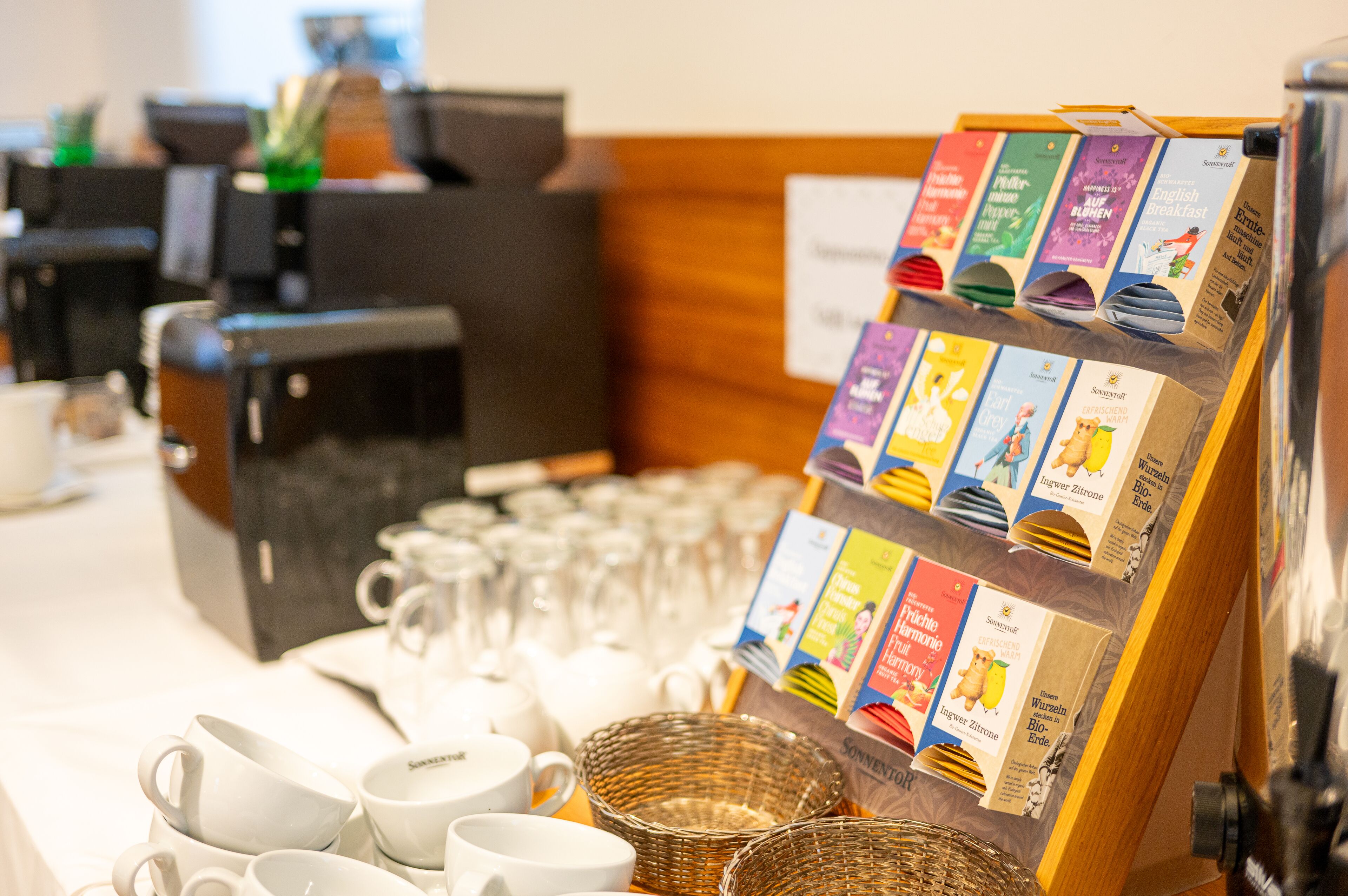 A coffee station with various coffee pods, cups, and a display of coffee-related books.