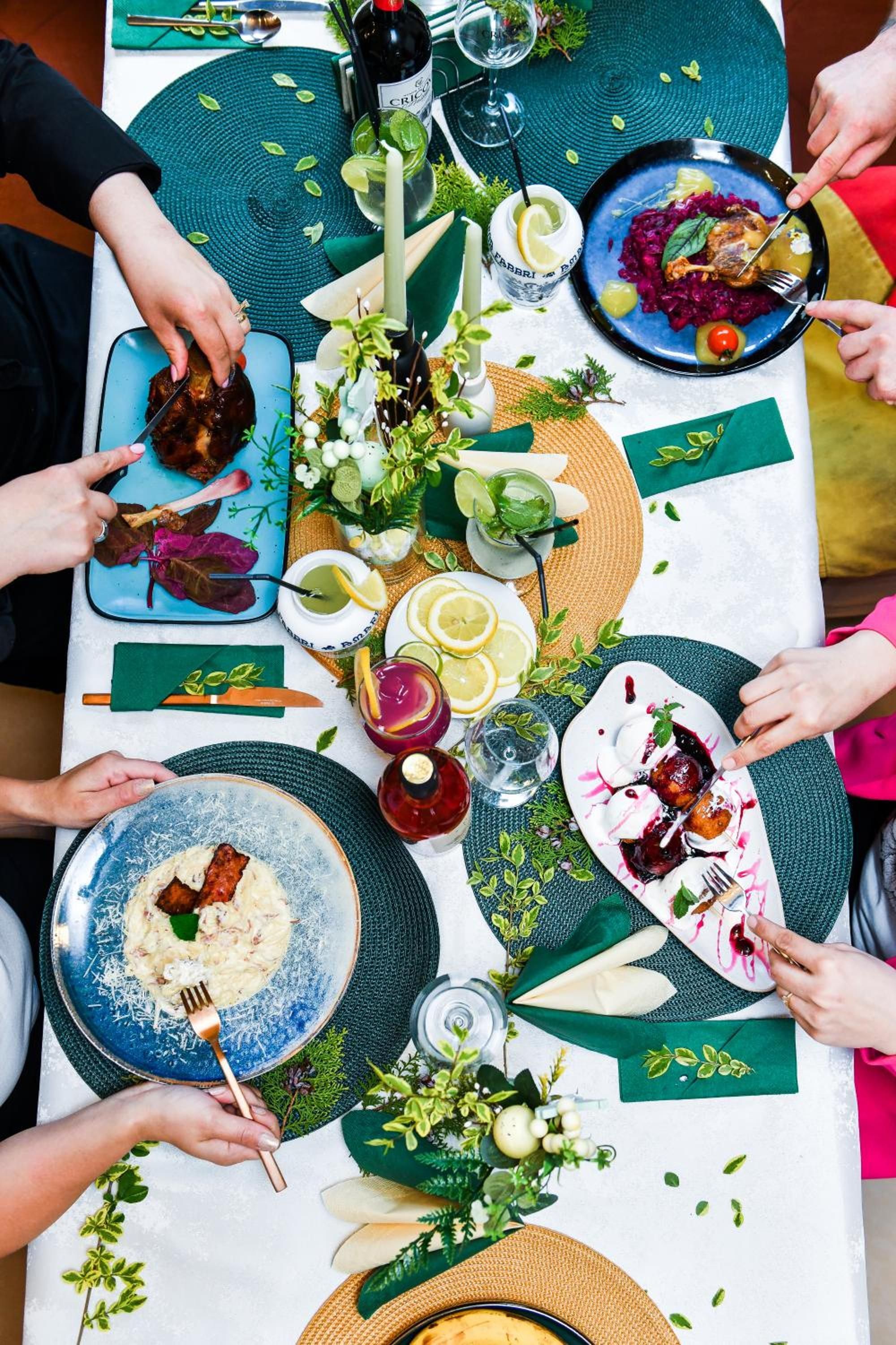 A dining table with various dishes, drinks, and a bottle of Crisco.
