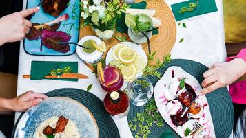 A dining table with various dishes, drinks, and a bottle of Crisco.