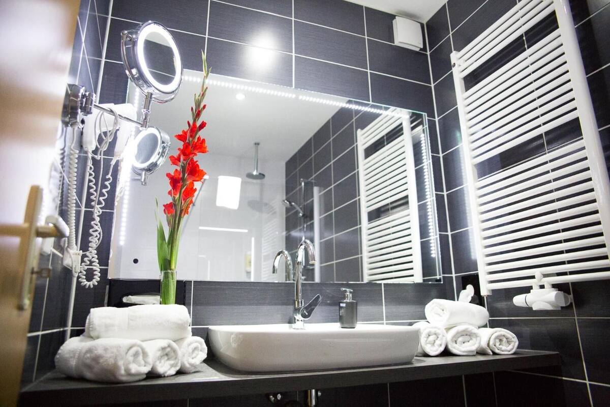 shower, rainfall showerhead, hair dryer, towels