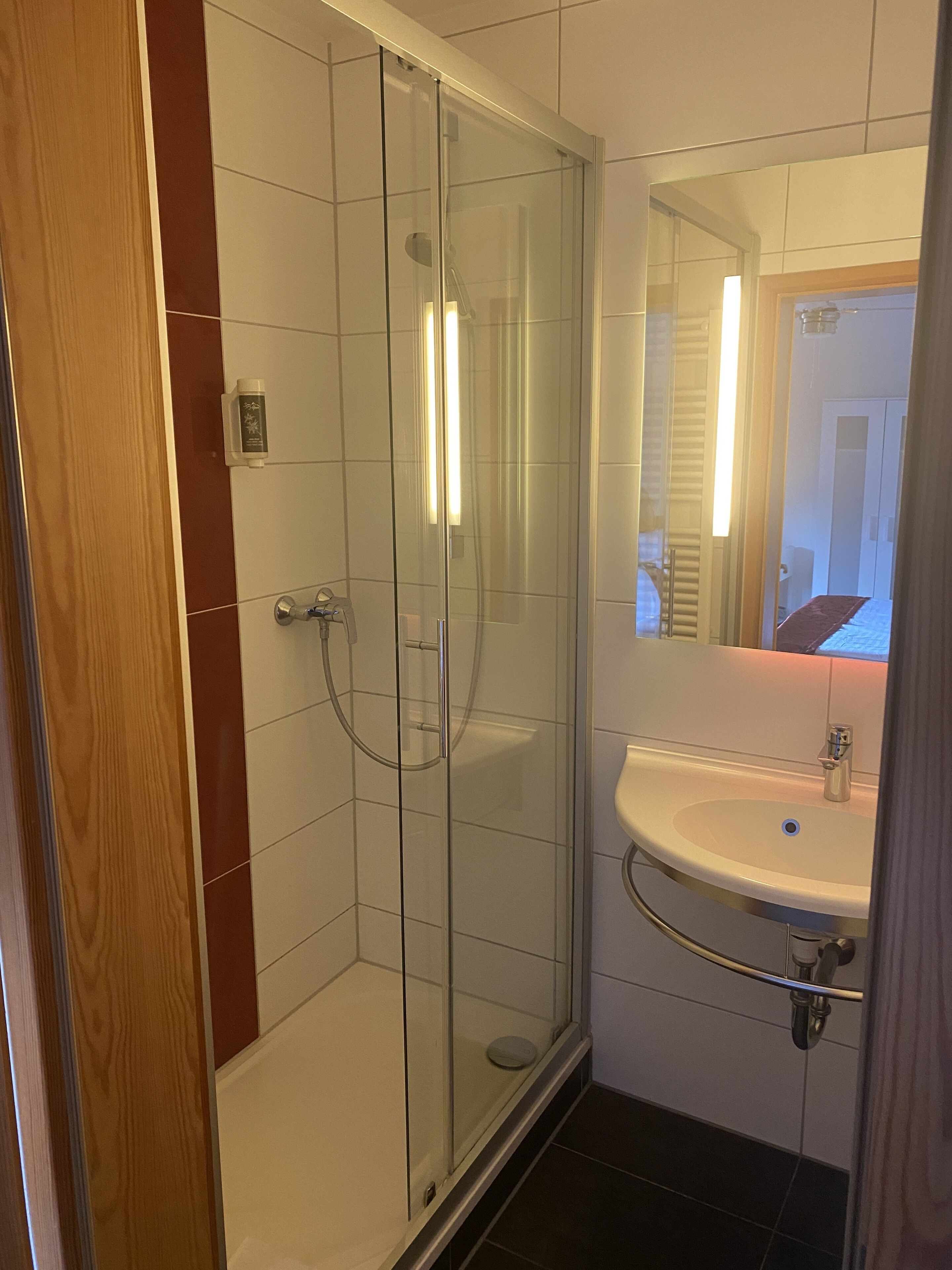 junior suite | bathroom | shower, rainfall showerhead, hair dryer, towels